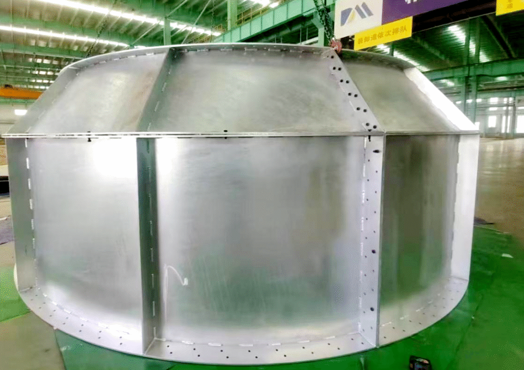 Large welded component prepared for containerized shipment