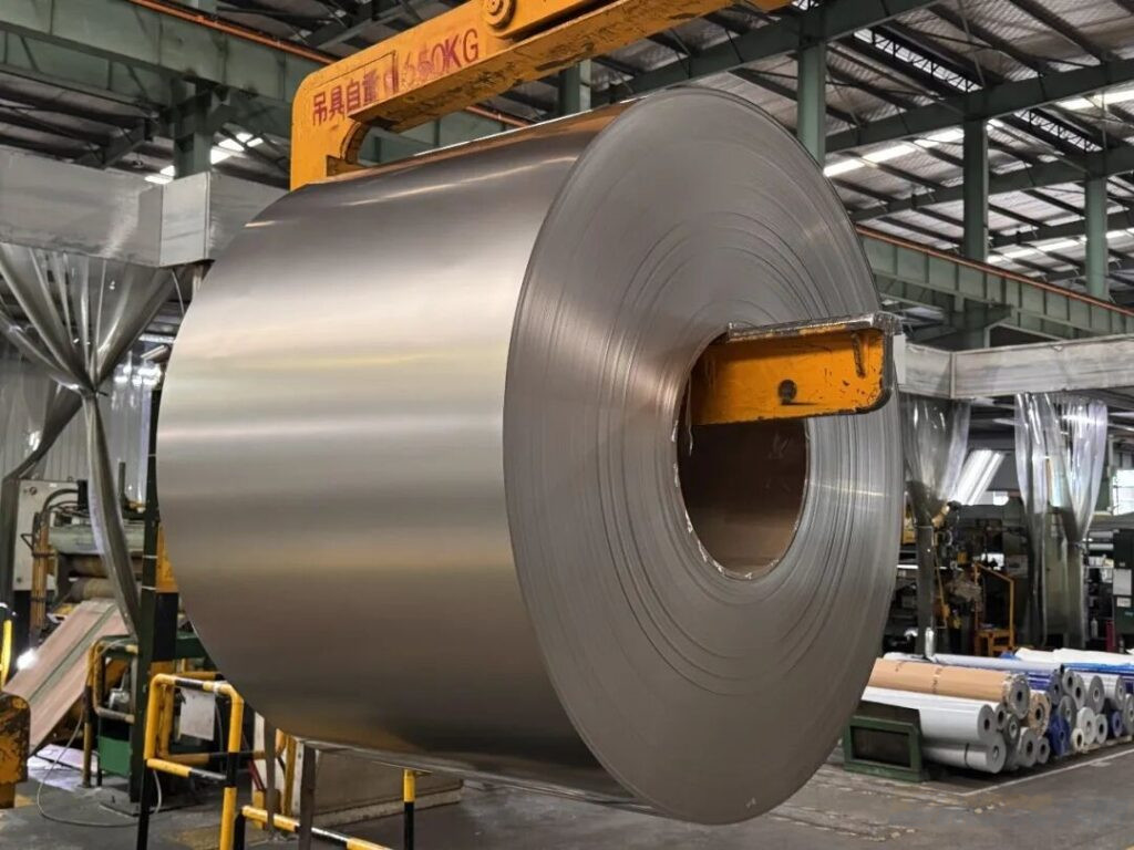 Titanium coil being lifted for precision handling and processing 1