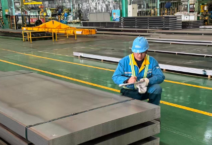 Warehouse staff inspecting steel plates before shipment 3
